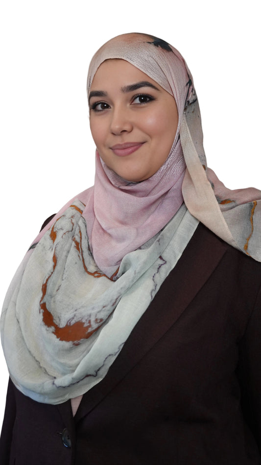 Rose Marble printed hijab featuring blush pink top and marble pattern drape worn by a smiling woman